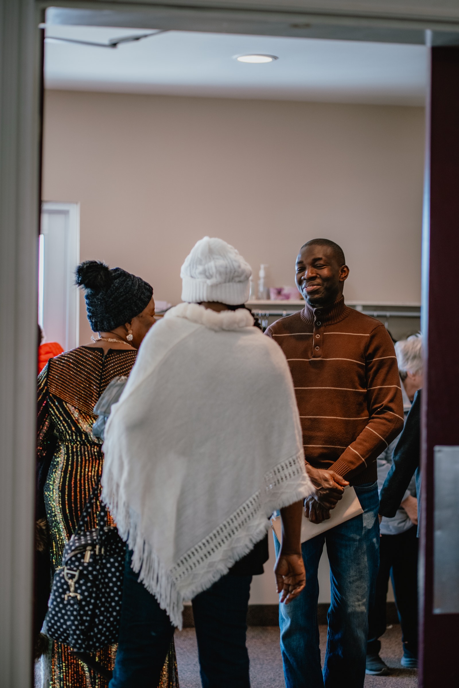 People greeting one another in the entrance at the Miramichi campus